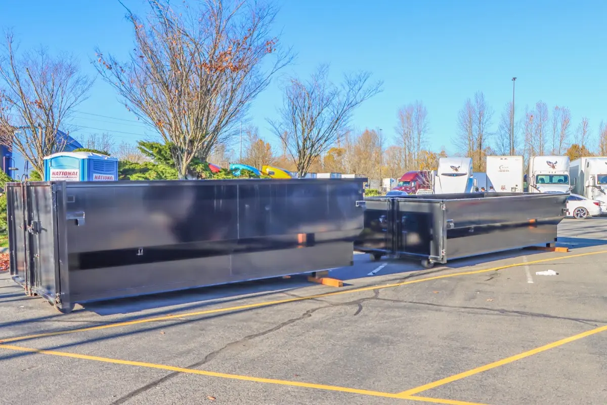 Professional dumpster rental service with roll-off container on residential driveway in Jacinto City